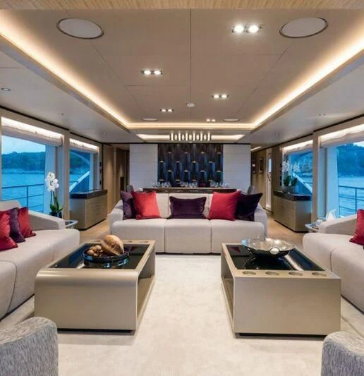 a living room with a white couch and a large window aboard LEGACY Yacht for Sale