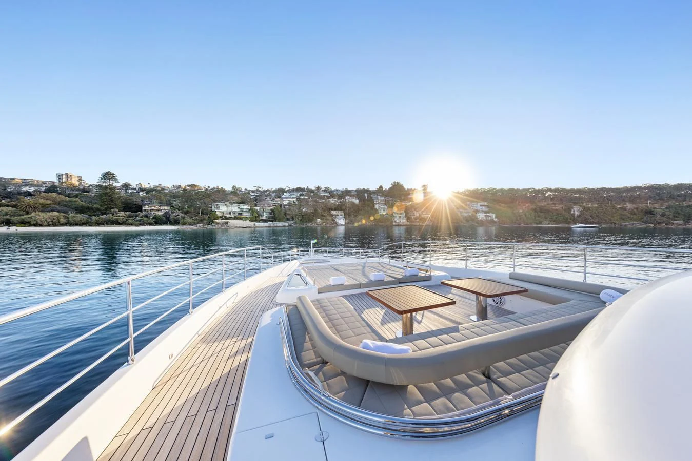 a deck with a view of a sunset and a body of water aboard LEGACY Yacht for Sale
