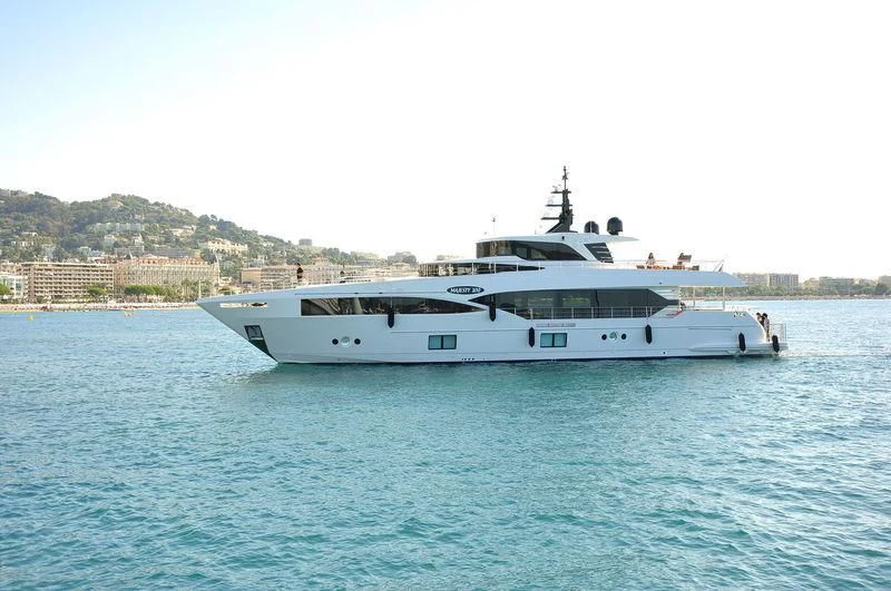 a white boat in the water aboard LEGACY Yacht for Sale