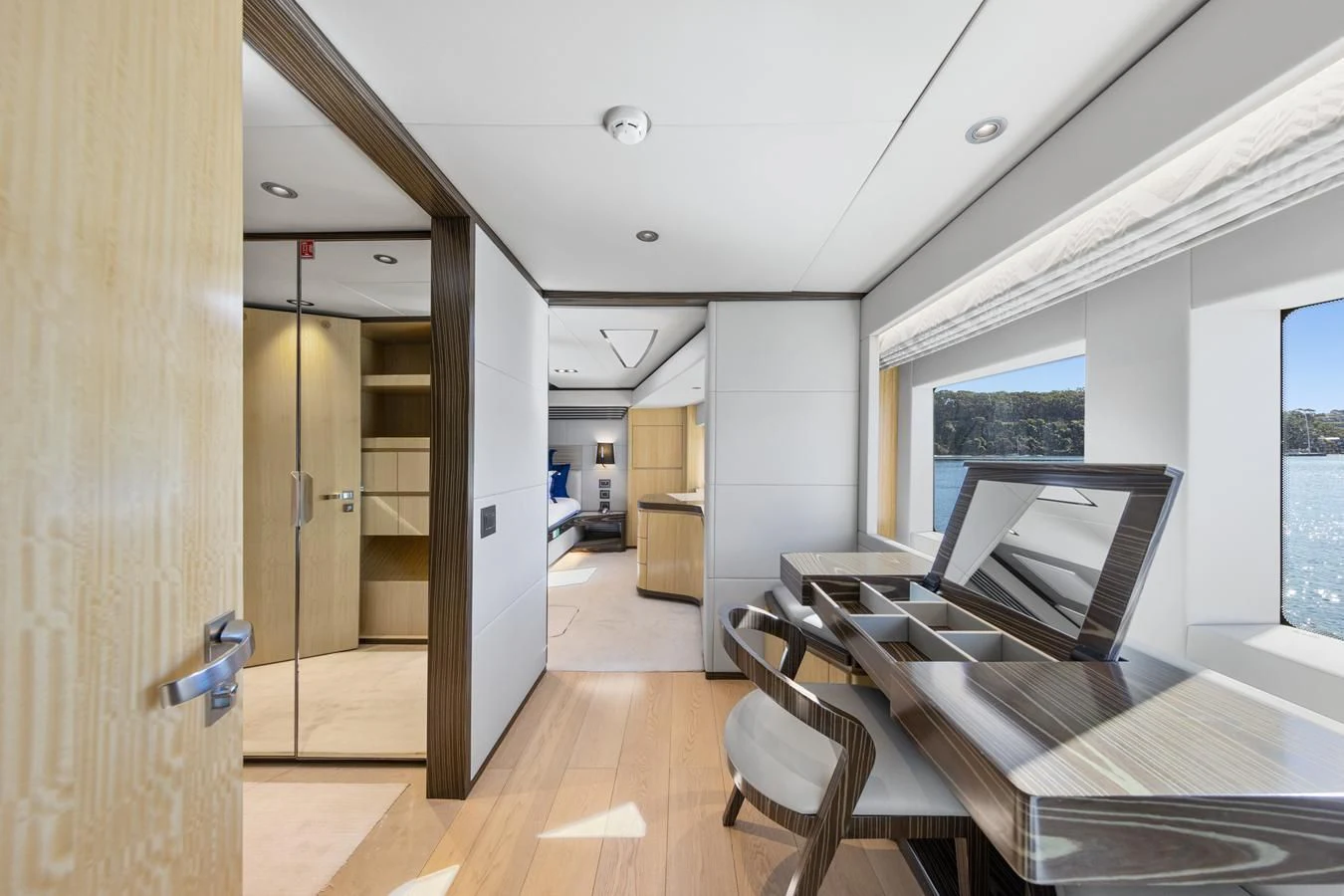 a room with a bed and desk aboard LEGACY Yacht for Sale