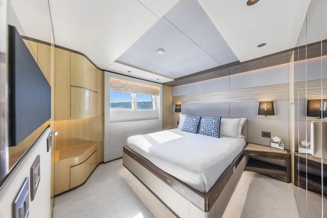 a room with a bed and a mirror aboard LEGACY Yacht for Sale
