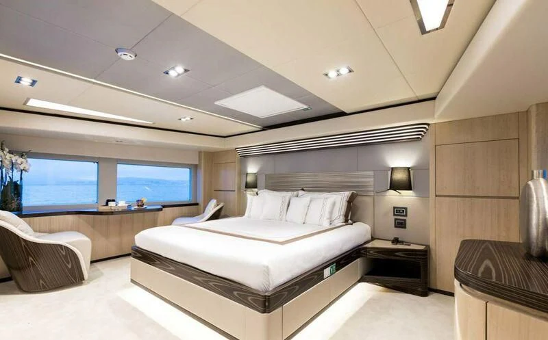 a room with a bed and a large window aboard LEGACY Yacht for Sale