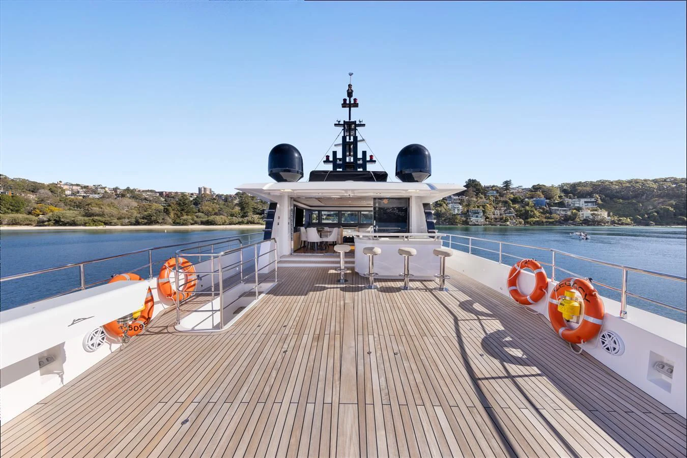 a deck with a boat on it and a large ship in the background aboard LEGACY Yacht for Sale