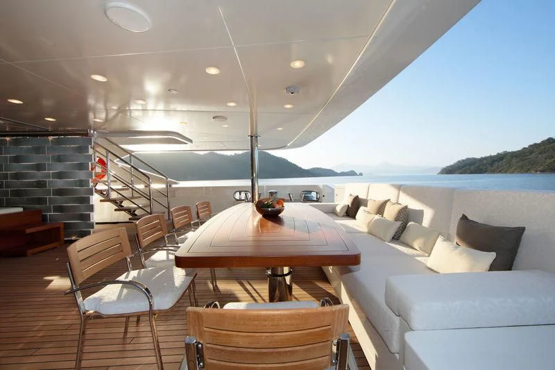a living room with a table and chairs aboard VICA Yacht for Sale
