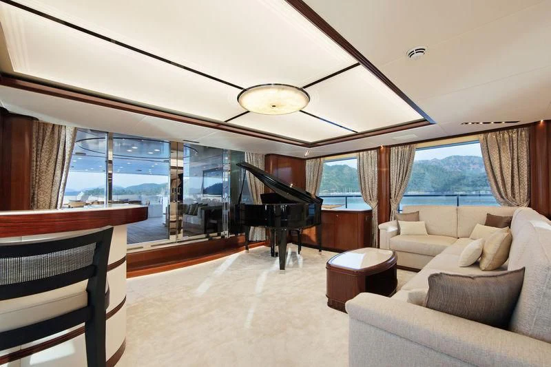 a living room with a piano aboard VICA Yacht for Sale