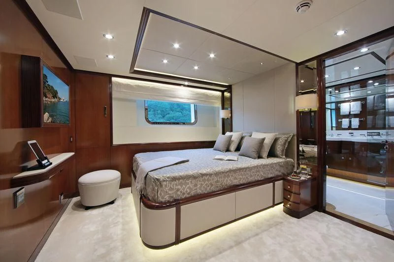 a bedroom with a bed and a desk aboard VICA Yacht for Sale