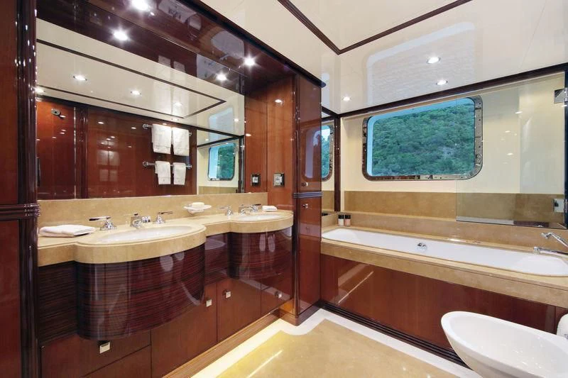 a bathroom with a large mirror aboard VICA Yacht for Sale