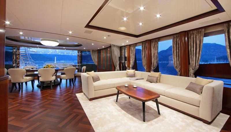 a living room with a couch and a table aboard VICA Yacht for Sale