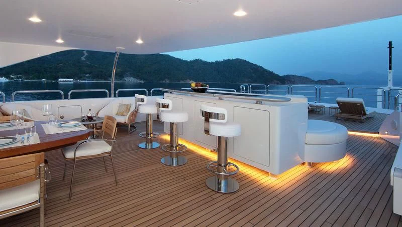a large room with tables and chairs aboard VICA Yacht for Sale