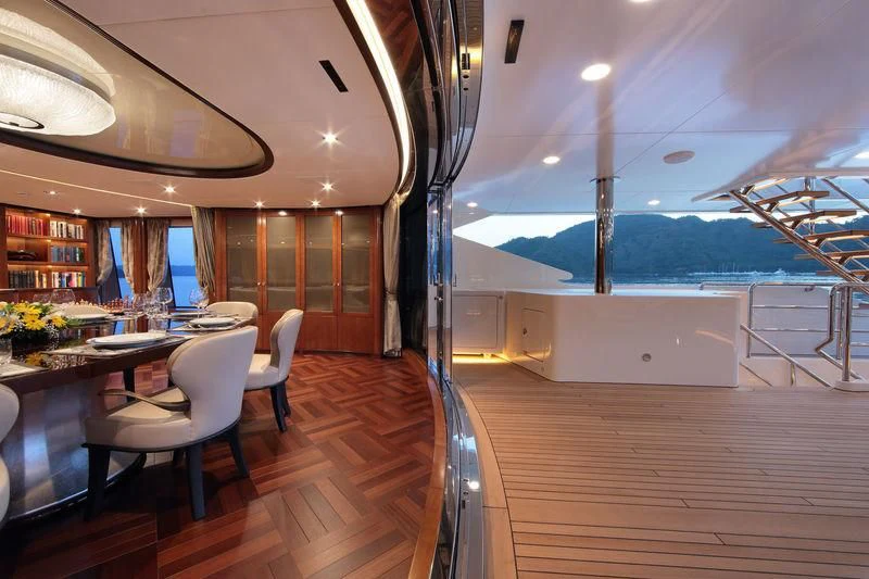 a room with tables and chairs aboard VICA Yacht for Sale