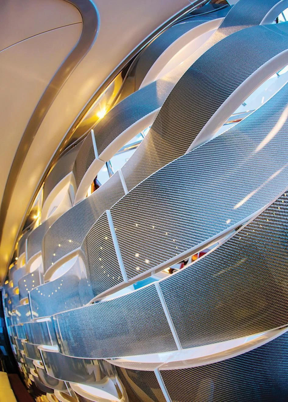 a close-up of a blue and orange spiral staircase aboard VICA Yacht for Sale