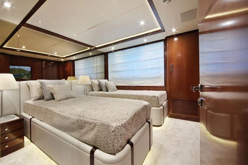 a room with a bed and a window aboard VICA Yacht for Sale