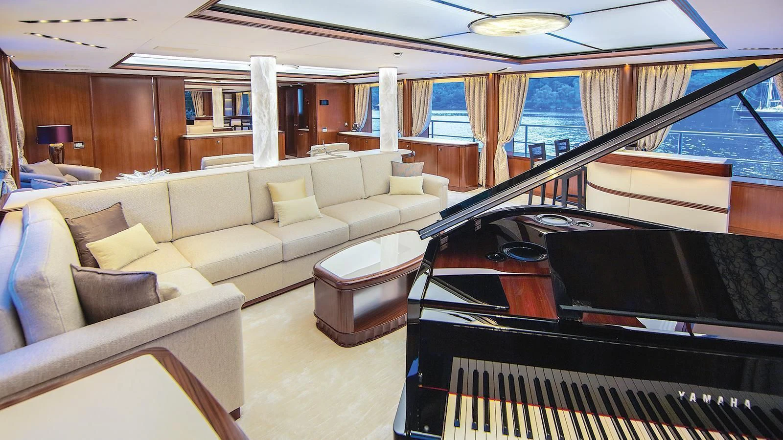 a living room with a piano aboard VICA Yacht for Sale