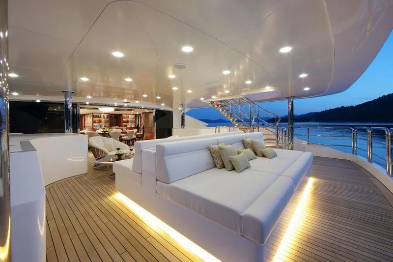 a large room with a bed and a large pool aboard VICA Yacht for Sale