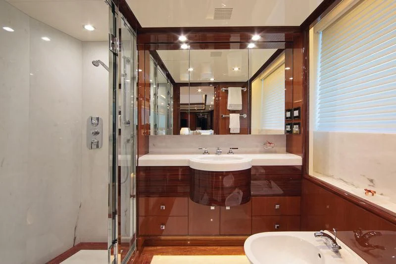 a bathroom with a large mirror aboard VICA Yacht for Sale