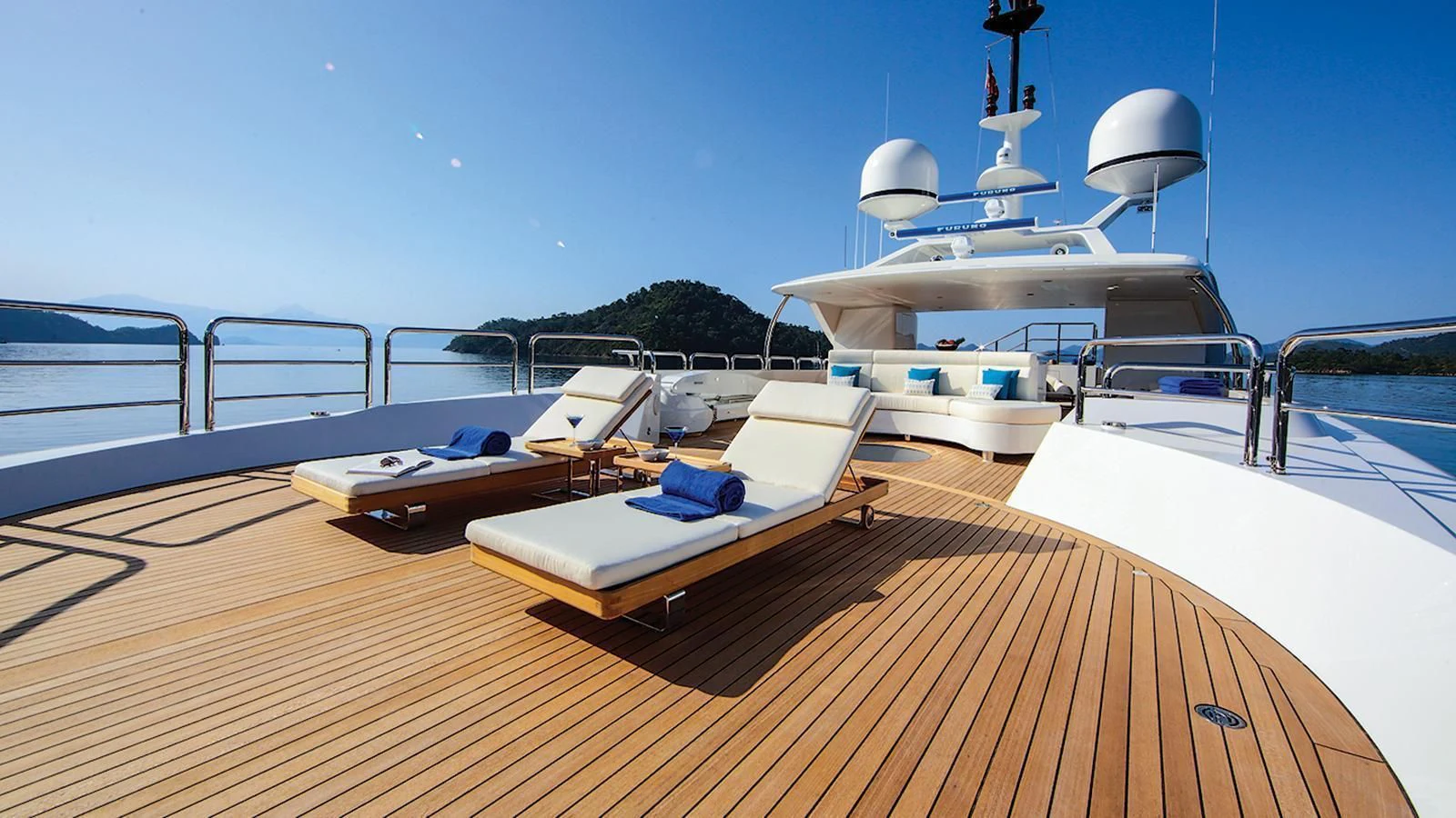 a deck with a boat and a desk on it aboard VICA Yacht for Sale