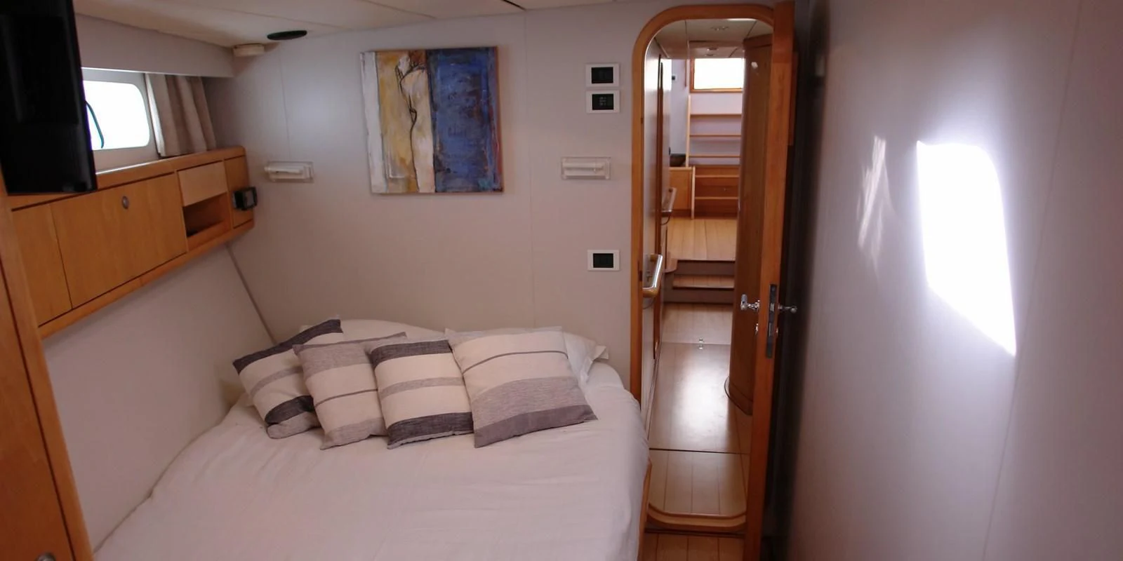 a bed with white sheets and pillows aboard DJANGO TOO Yacht for Charter