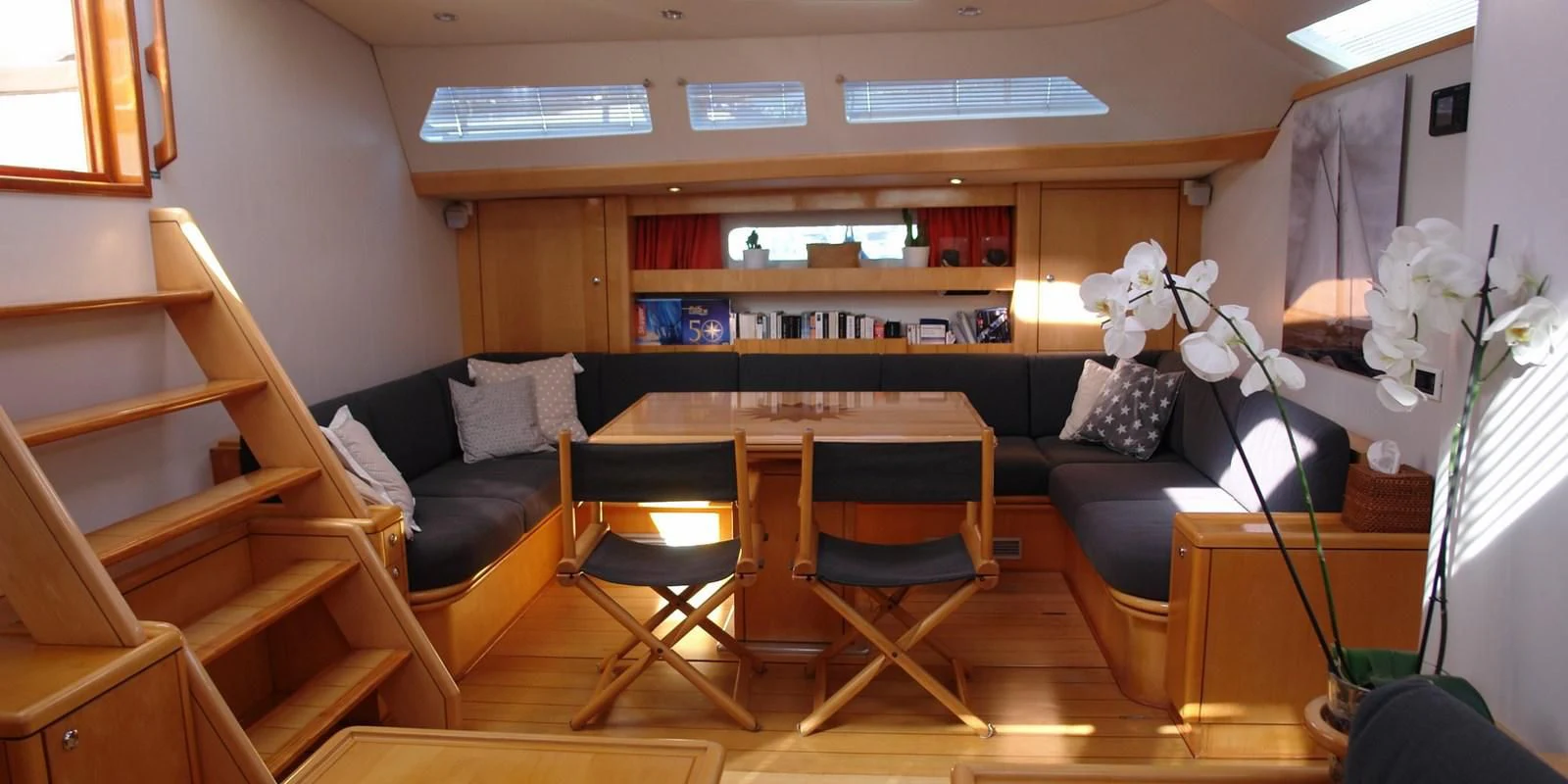 a room with a desk and chairs aboard DJANGO TOO Yacht for Charter