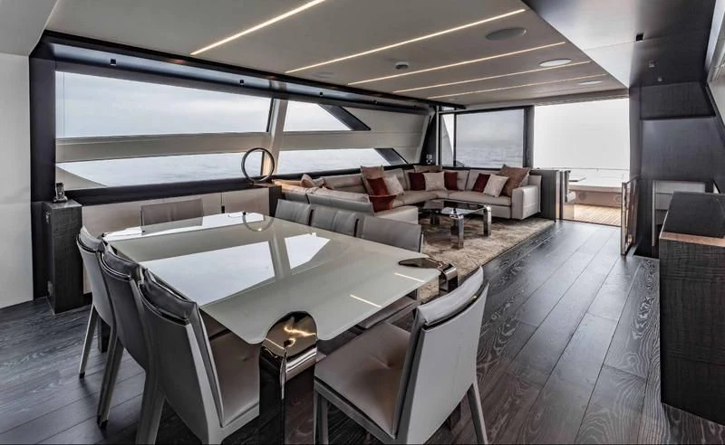 a large room with a table and chairs aboard JUST 4 Yacht for Sale