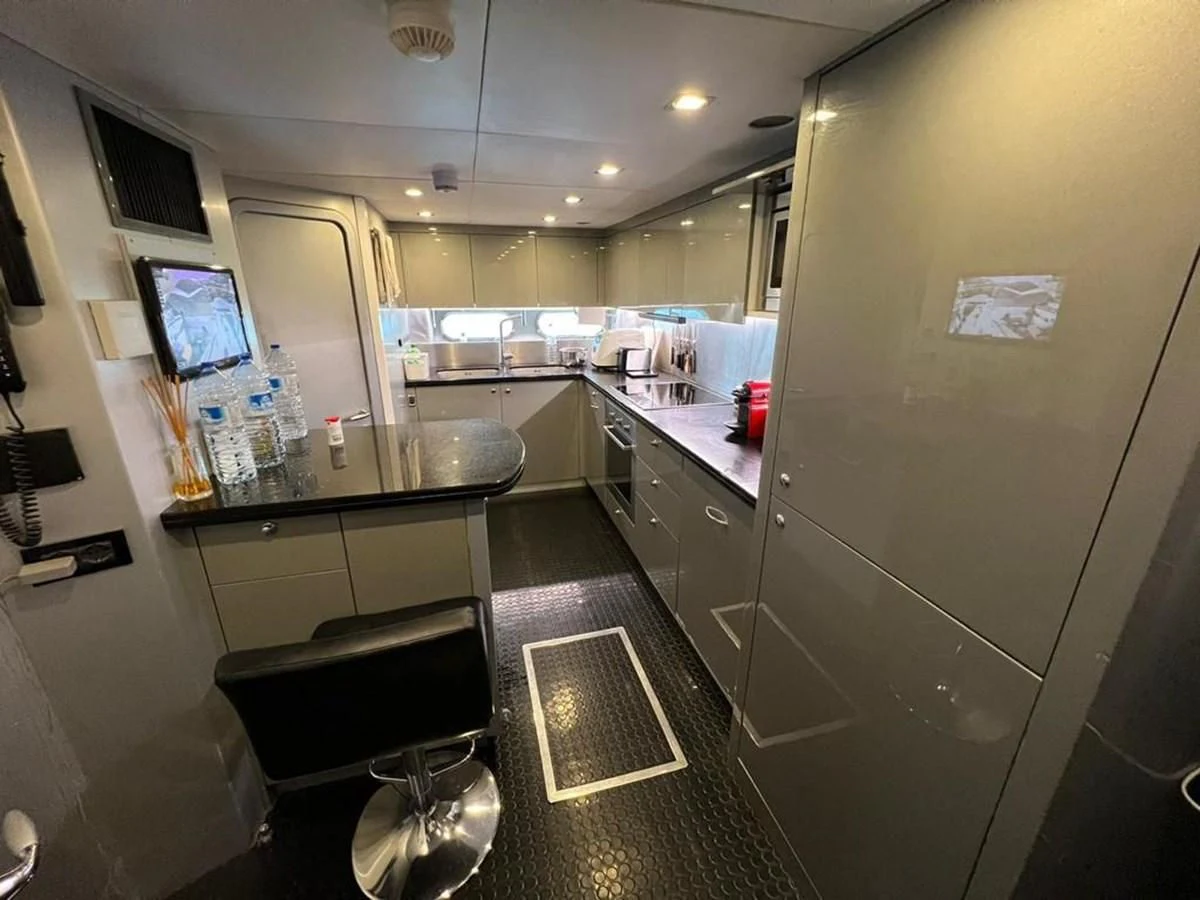 a kitchen with a sink and a tv on the wall aboard EYE Yacht for Sale