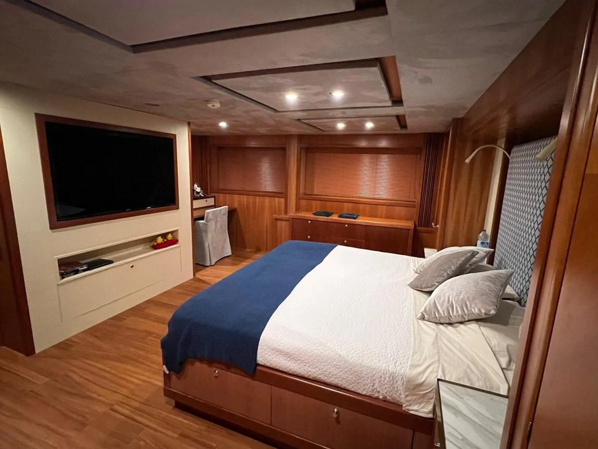 a bedroom with a bed and a television aboard EYE Yacht for Sale