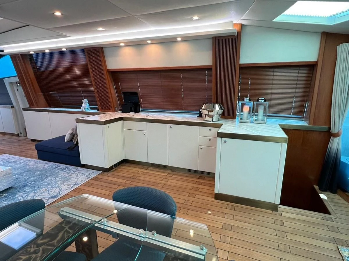 a room with a wood floor and a desk with a chair and a computer on it aboard EYE Yacht for Sale