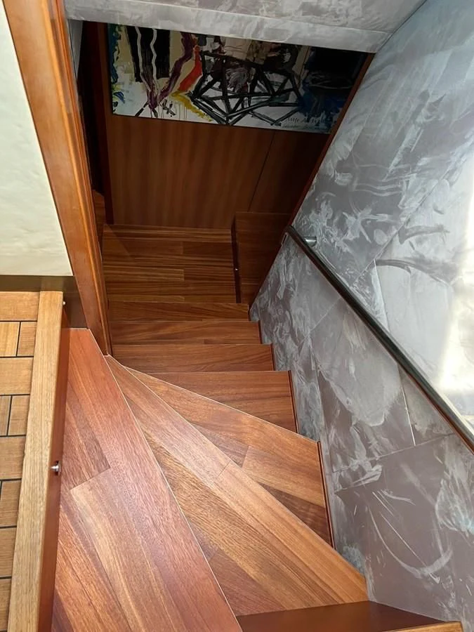 a staircase with a wood floor aboard EYE Yacht for Sale