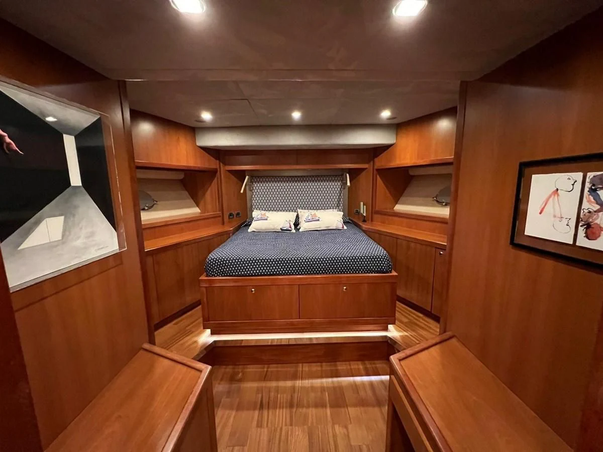 a bed in a wooden room aboard EYE Yacht for Sale