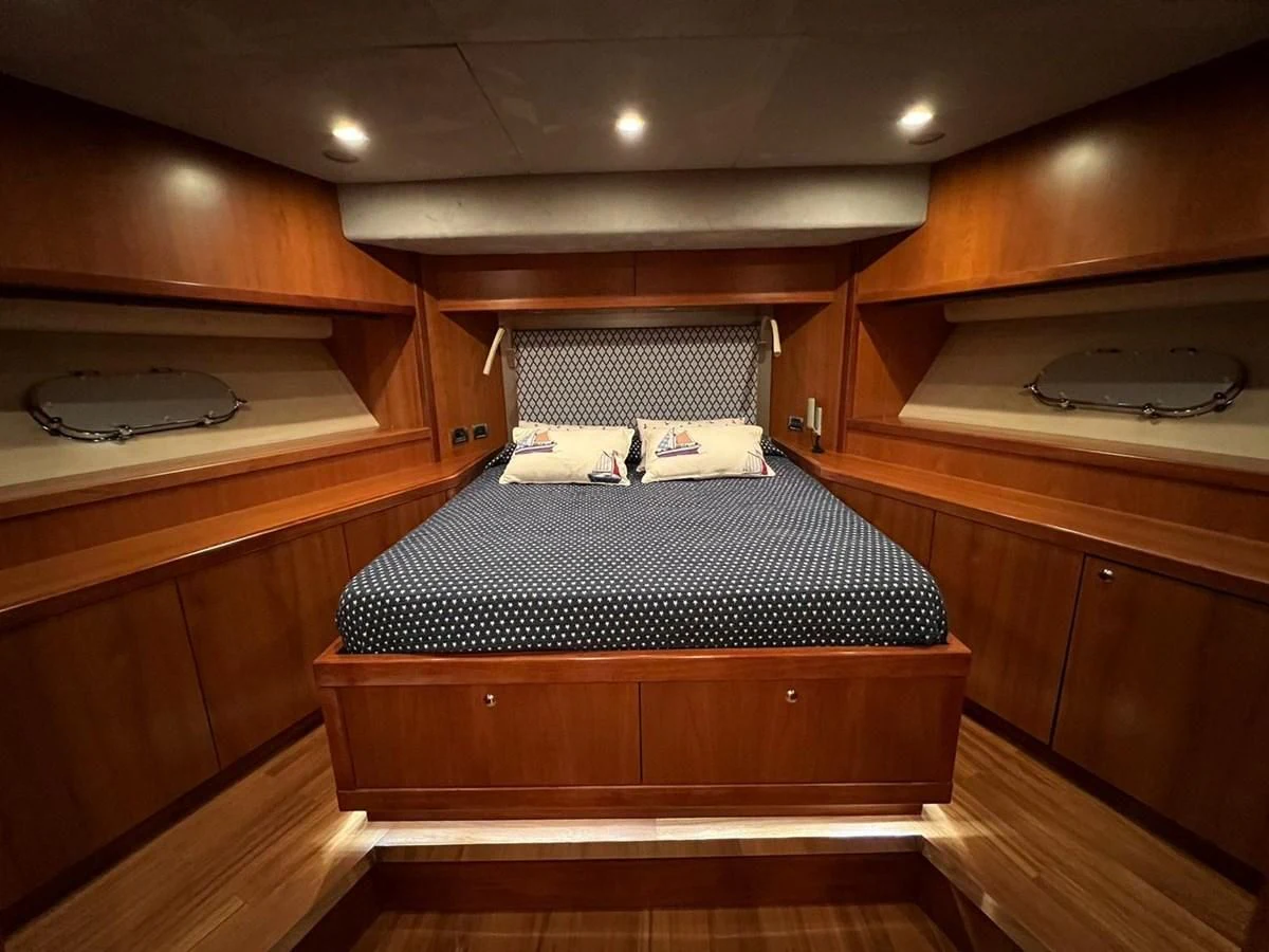 a bed in a wooden room aboard EYE Yacht for Sale