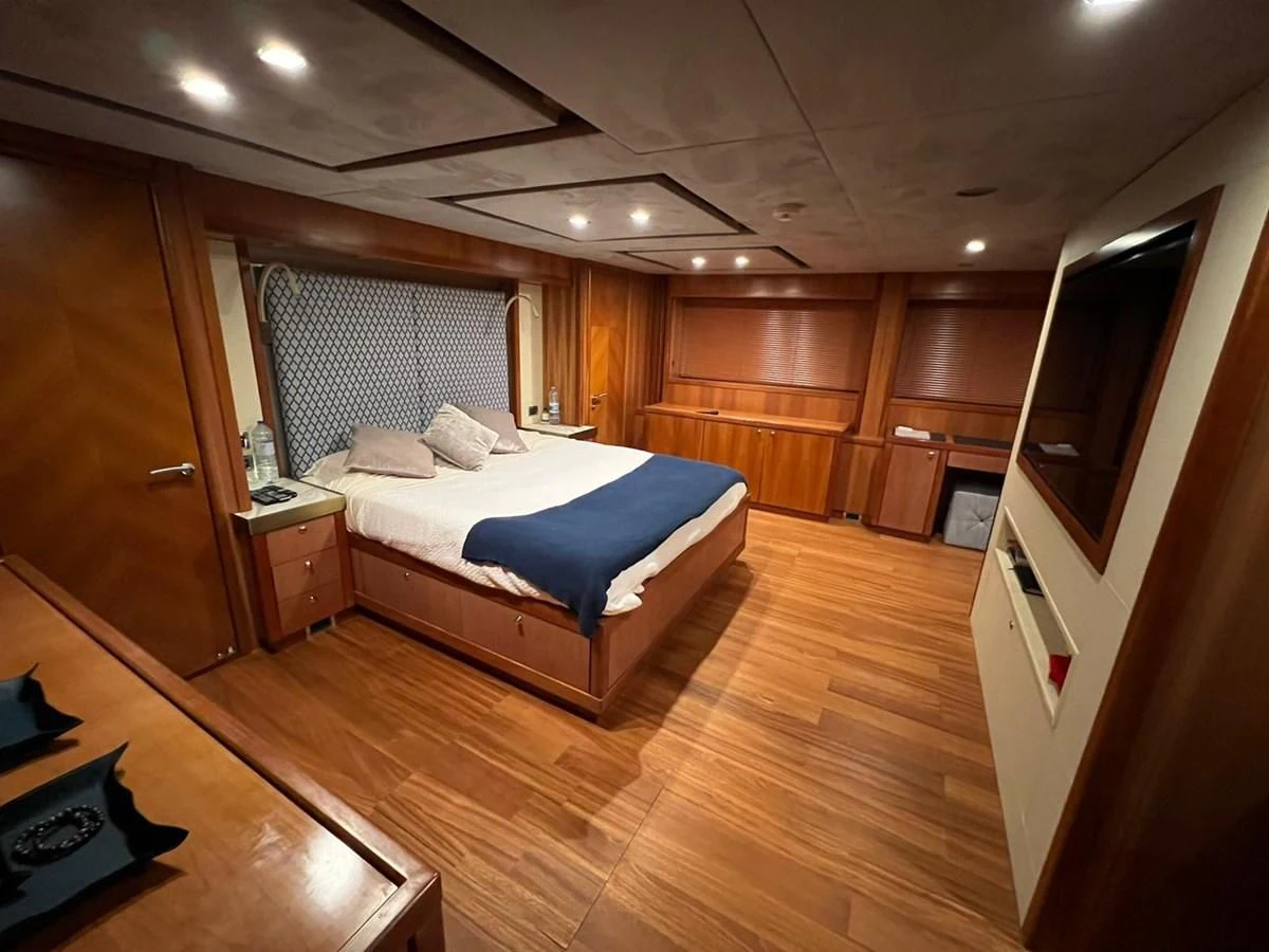 a bedroom with a bed and a tv aboard EYE Yacht for Sale
