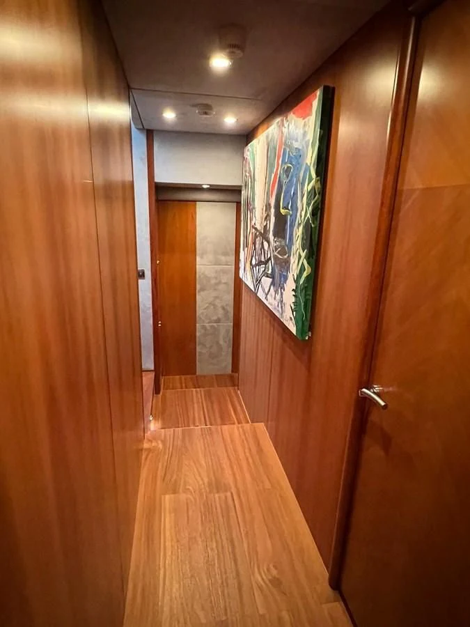 a hallway with a door and art on the wall aboard EYE Yacht for Sale