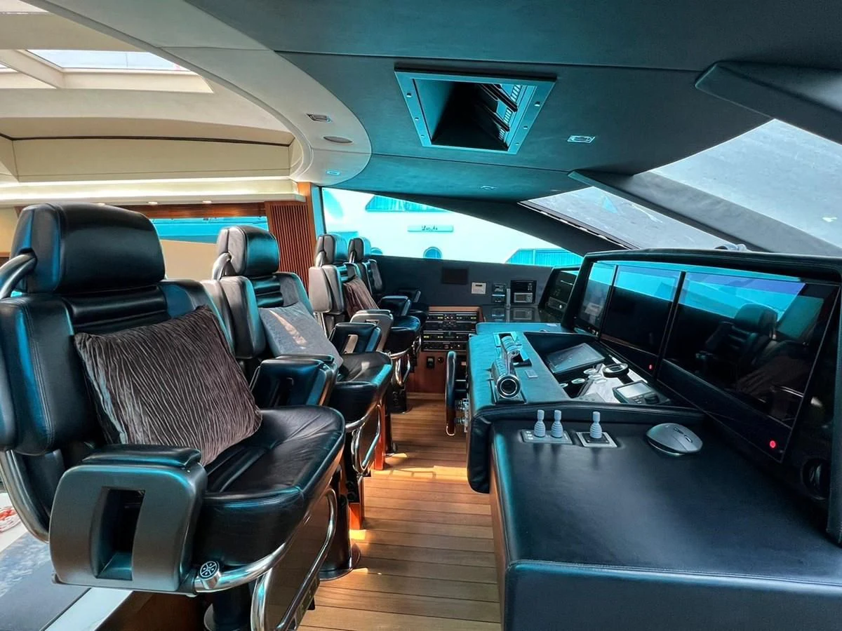 inside of a vehicle with many seats and a table with chairs and a computer monitor aboard EYE Yacht for Sale