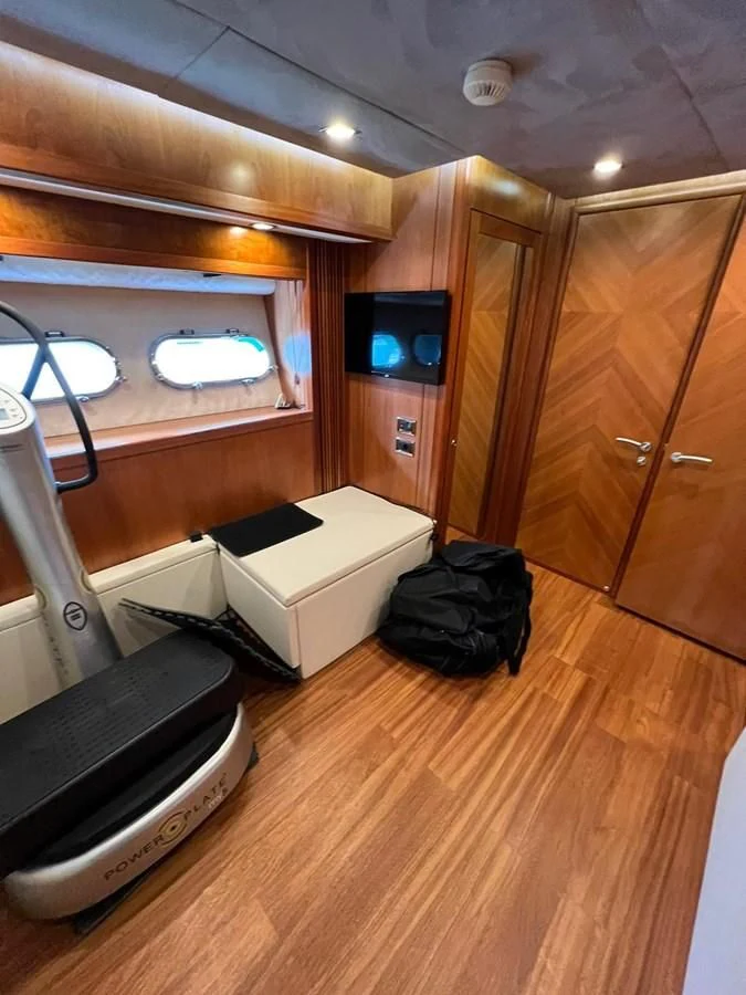 a room with a tv and a bed aboard EYE Yacht for Sale