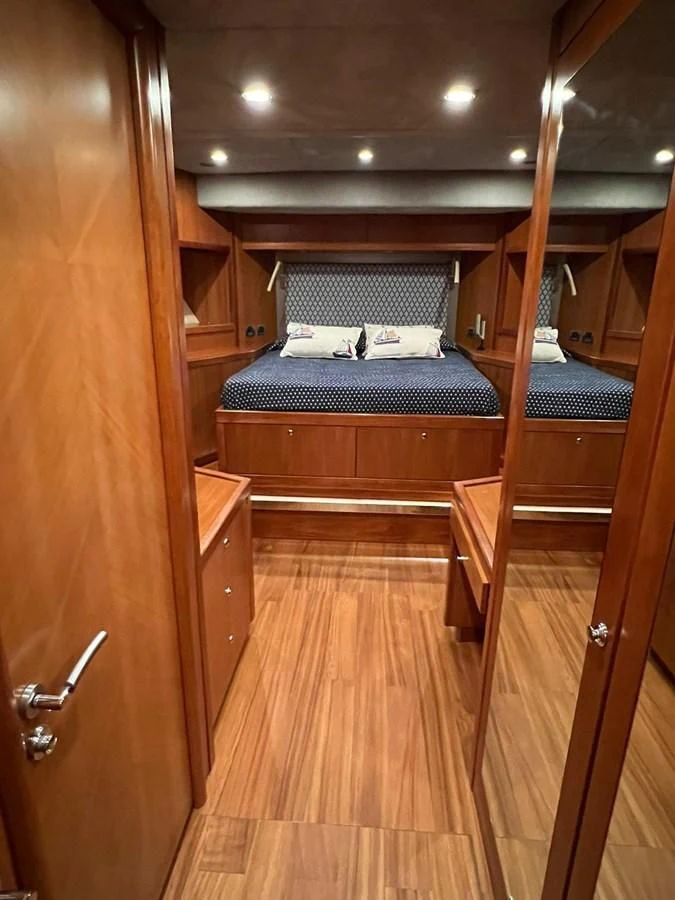 a wooden room with a bed aboard EYE Yacht for Sale