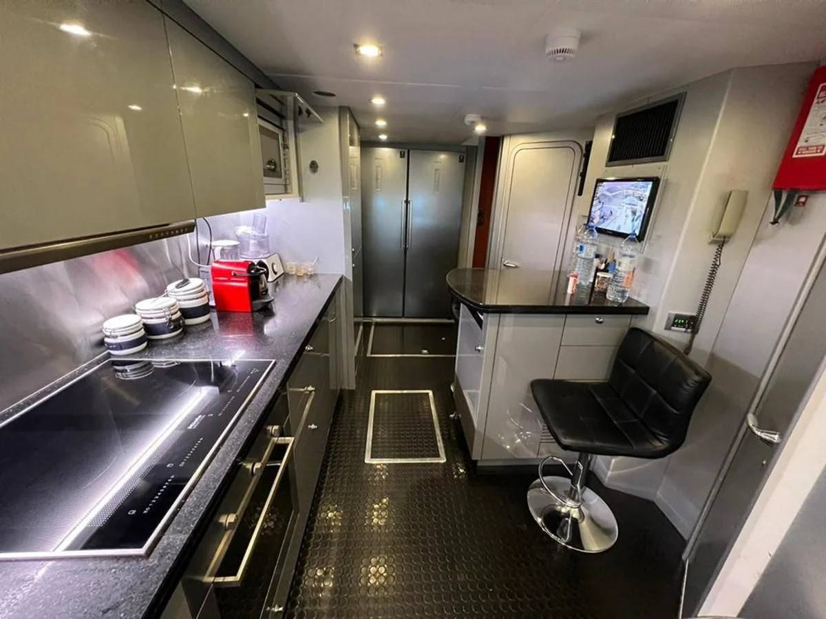 a kitchen with a bar and a chair aboard EYE Yacht for Sale