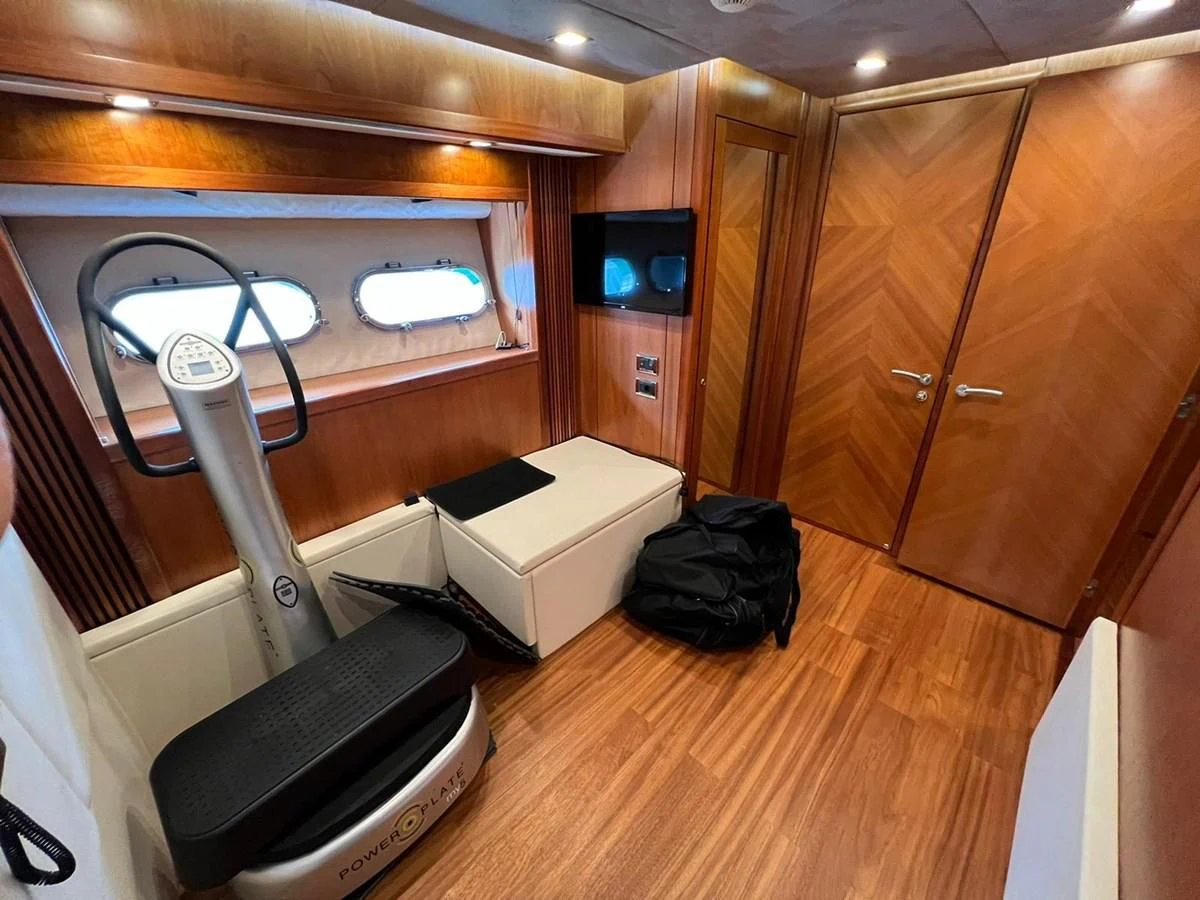 a room with a desk and a chair and a television aboard EYE Yacht for Sale