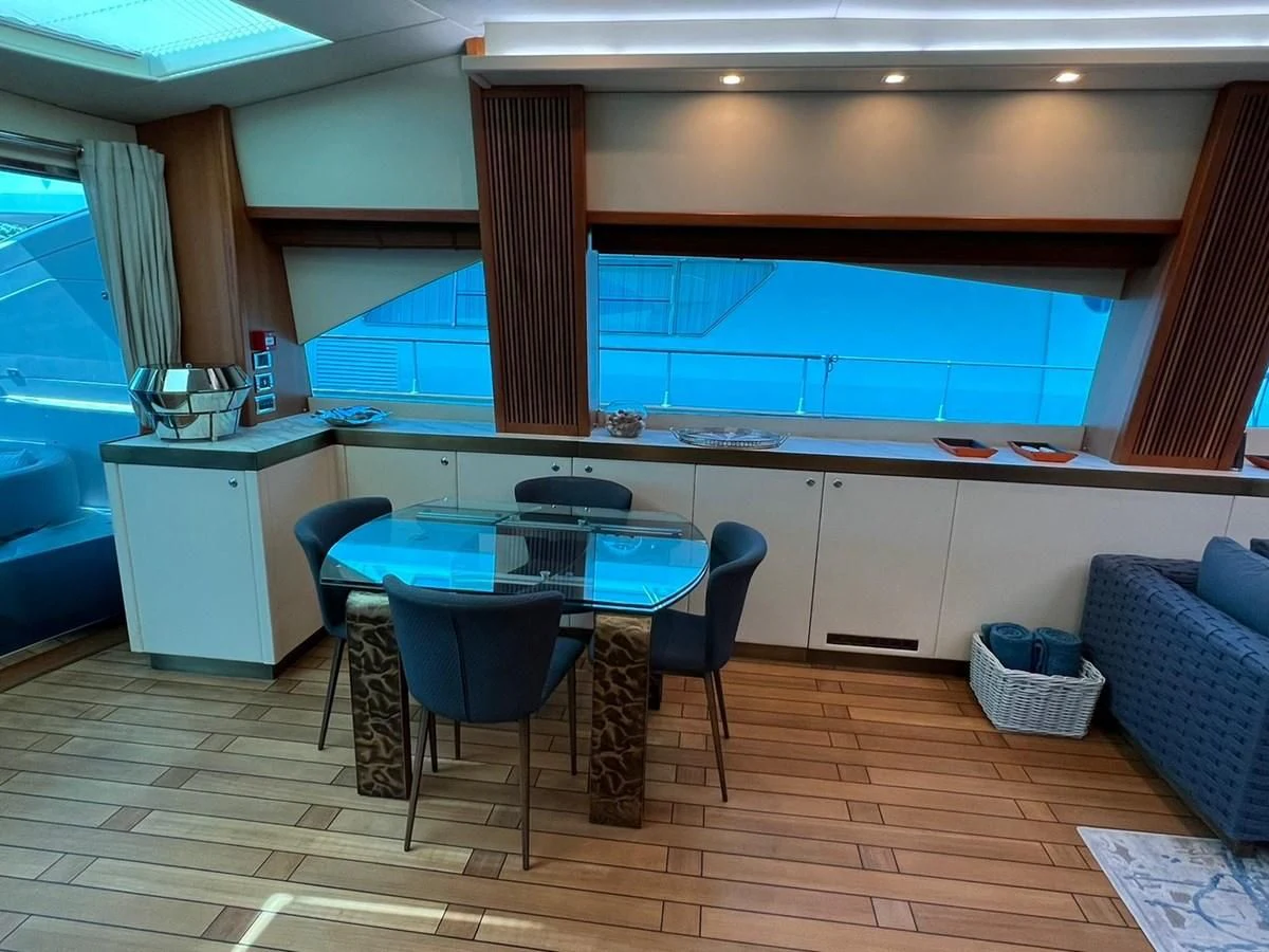 a room with a table and chairs aboard EYE Yacht for Sale