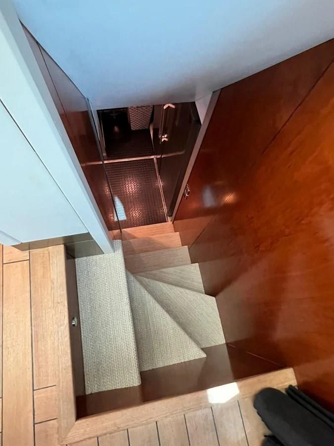 a staircase with a white carpet aboard EYE Yacht for Sale
