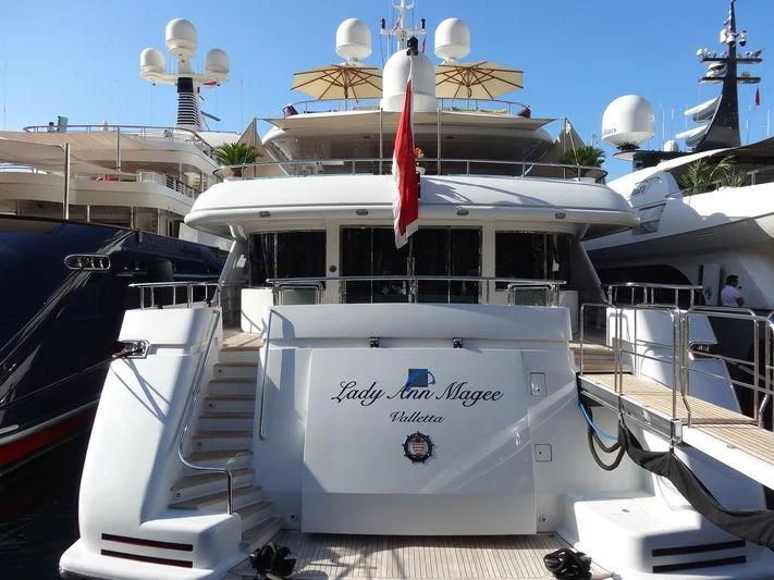 a boat with a flag on the front aboard LADY ANN MAGEE Yacht for Sale