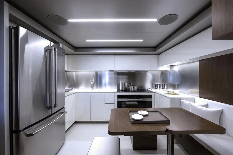a kitchen with a stainless steel refrigerator aboard GIO4 Yacht for Sale