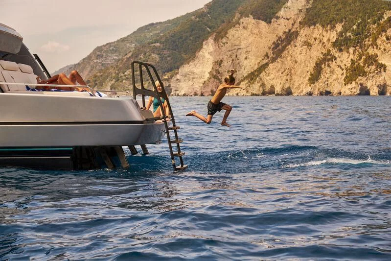 a person jumping into the water aboard GIO4 Yacht for Sale