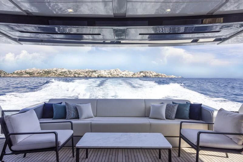 a patio with a view of the ocean and mountains in the background aboard GIO4 Yacht for Sale