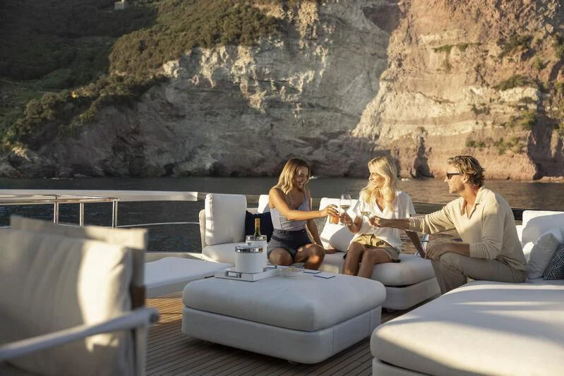 a group of people sitting on a couch aboard GIO4 Yacht for Sale