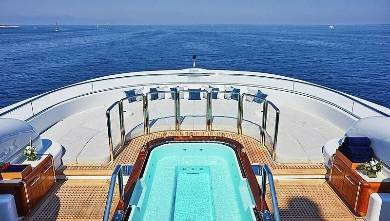 a deck with a large ship in the water aboard BARBARA Yacht for Charter