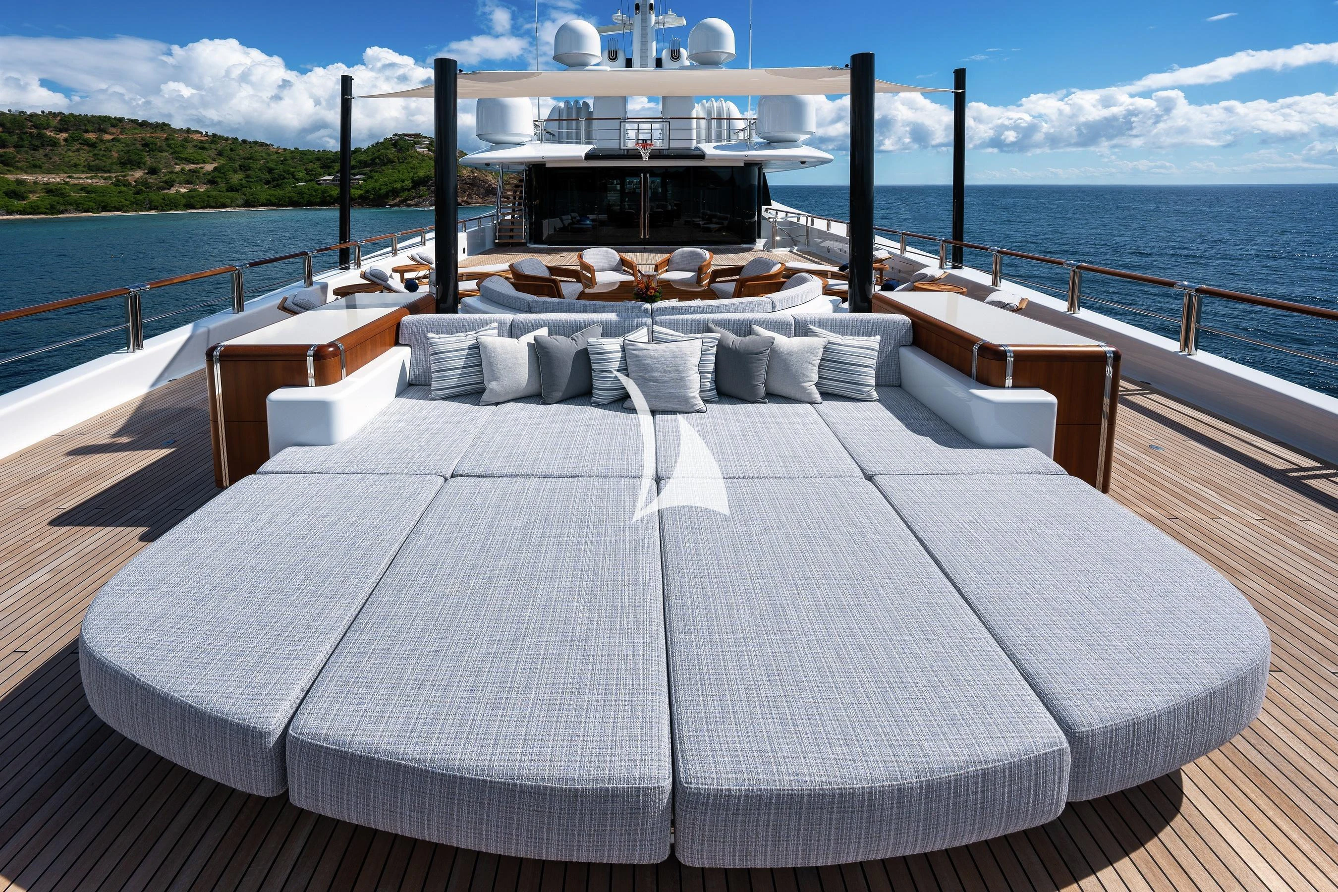 a table with chairs on it next to a body of water aboard BARBARA Yacht for Charter
