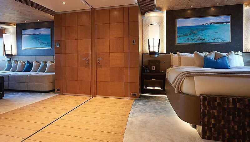 a room with a bed and a television aboard BARBARA Yacht for Charter