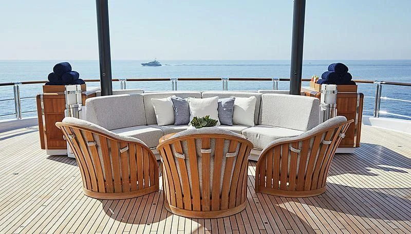 a couch and chairs on a deck overlooking a body of water aboard BARBARA Yacht for Charter
