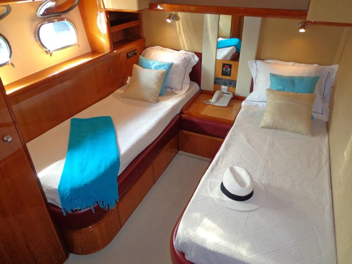 a bed with a white bed spread aboard FERRETTI 760 Yacht for Sale