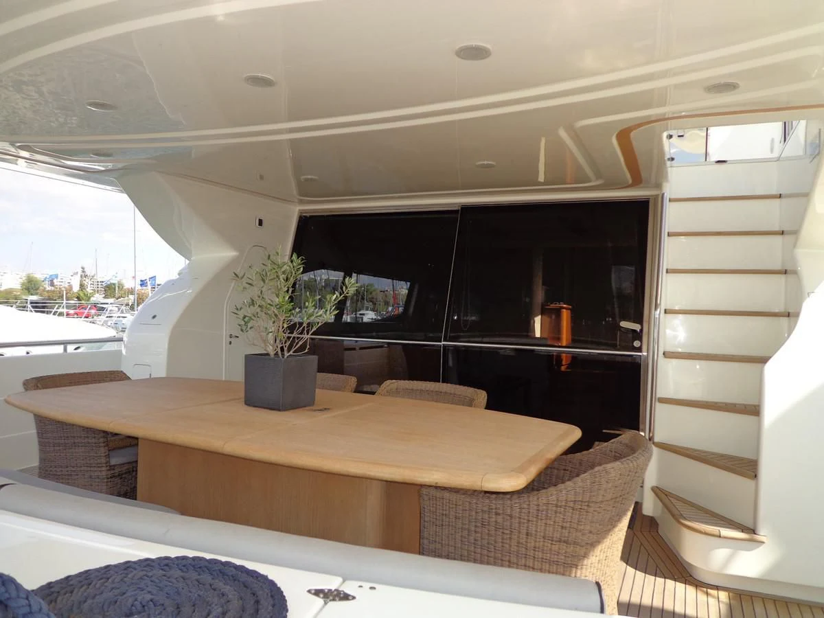 a room with a table and chairs aboard FERRETTI 760 Yacht for Sale