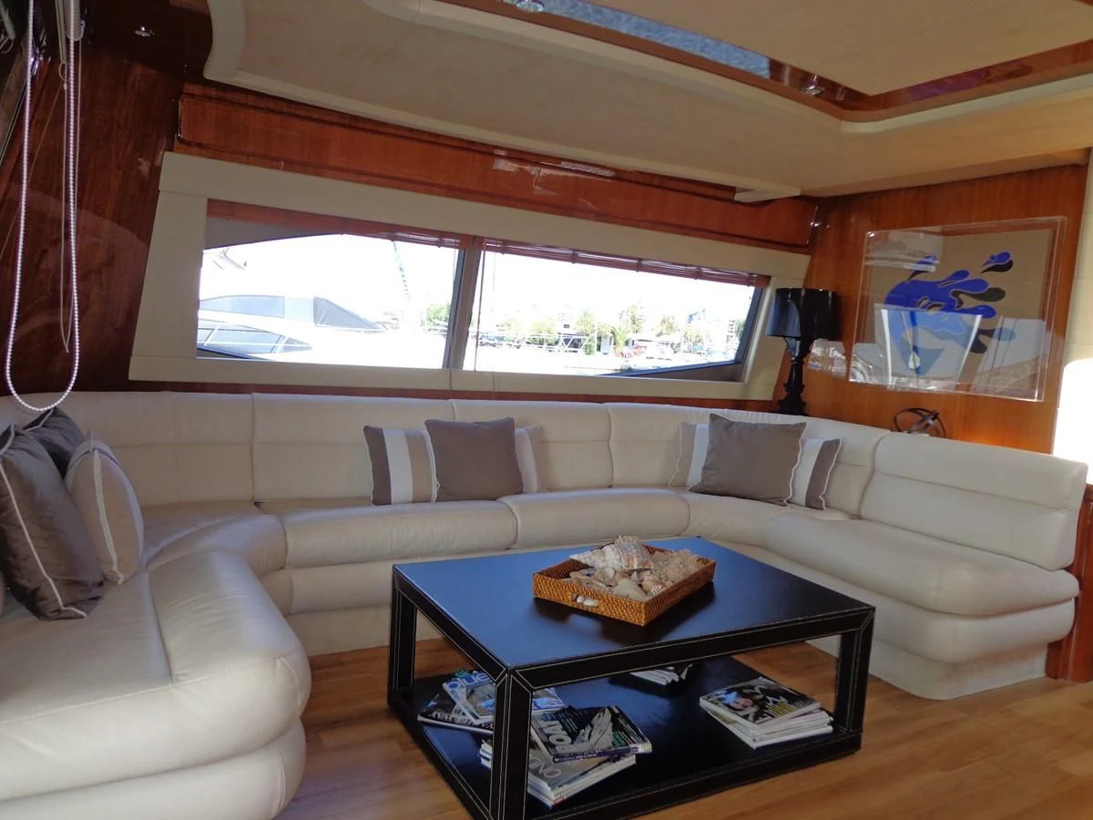 a living room with a couch and a coffee table aboard FERRETTI 760 Yacht for Sale